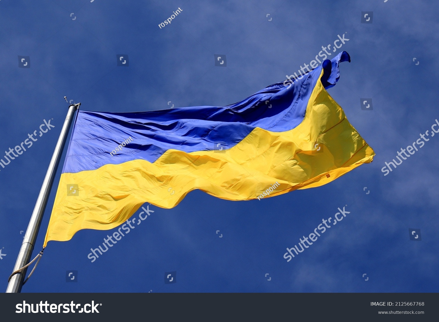 Ukraine flag large national symbol fluttering in blue sky. Large yellow blue Ukrainian state flag, Dnipro city, Independence Constitution Day, National holiday.  #2125667768