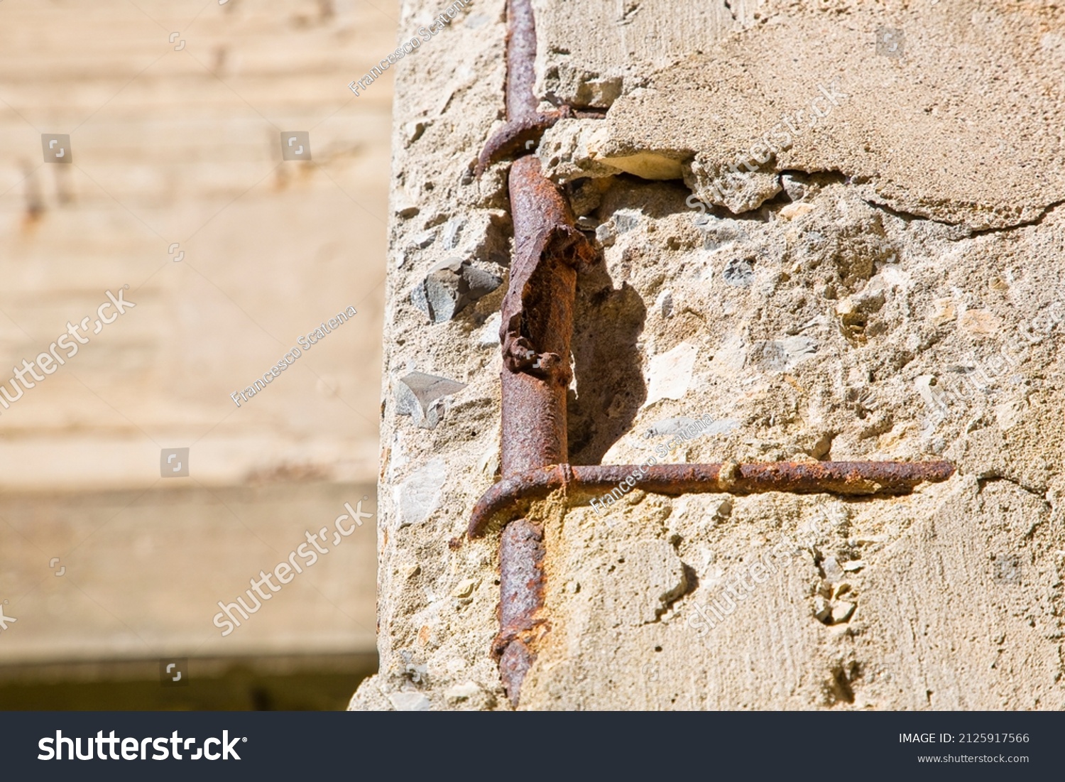 Old reinforced concrete structure with damaged and rusty metallic reinforcement bars. #2125917566