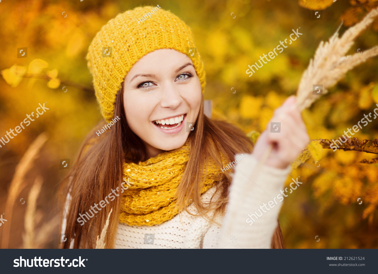 Portrait of beautiful girl with scarf and hat in yellow autumn nature #212621524