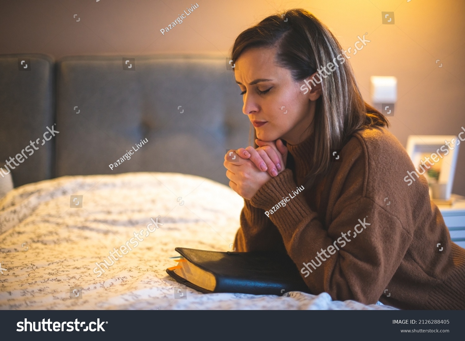 Woman with pray and worship god in her bedroom #2126288405
