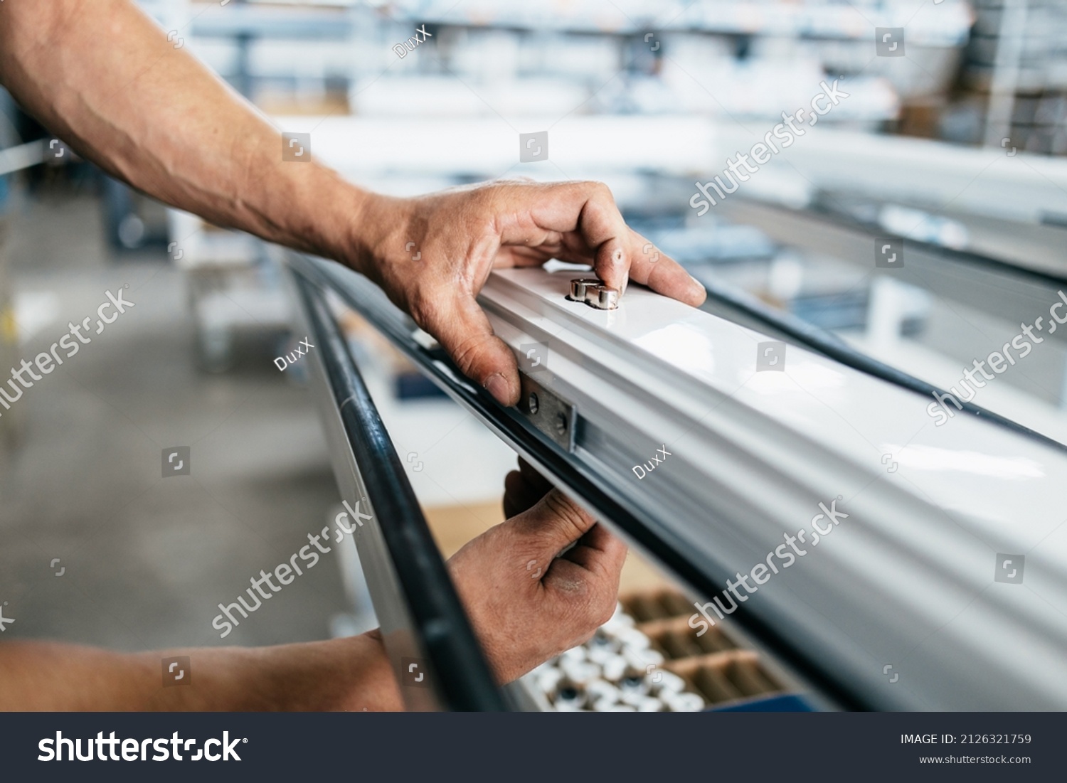 Manual worker assembling PVC doors and windows. Manufacturing jobs. Selective focus. Factory for aluminum and PVC windows and doors production. #2126321759