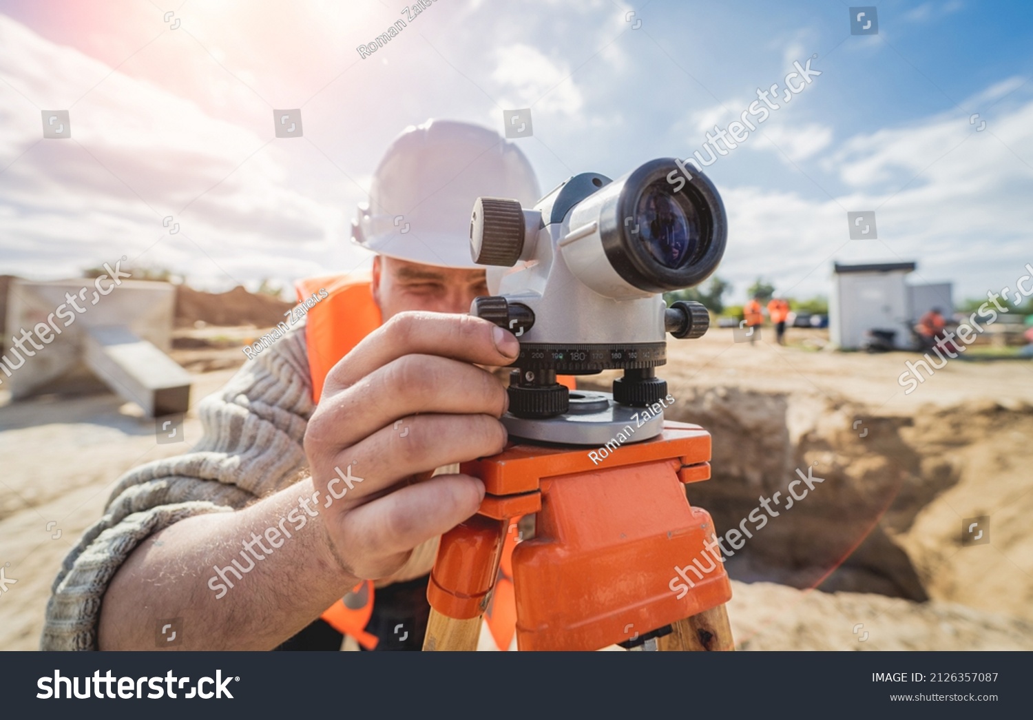 Surveyor worker with theodolite equipment at construction site #2126357087