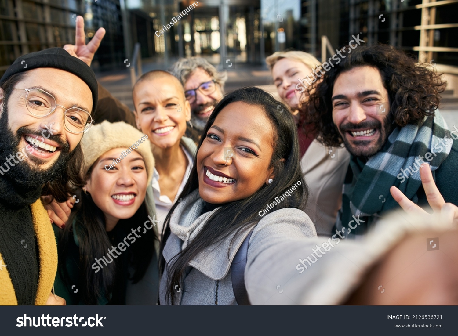 Selfie of a group of happy business people taking photo with a phone #2126536721