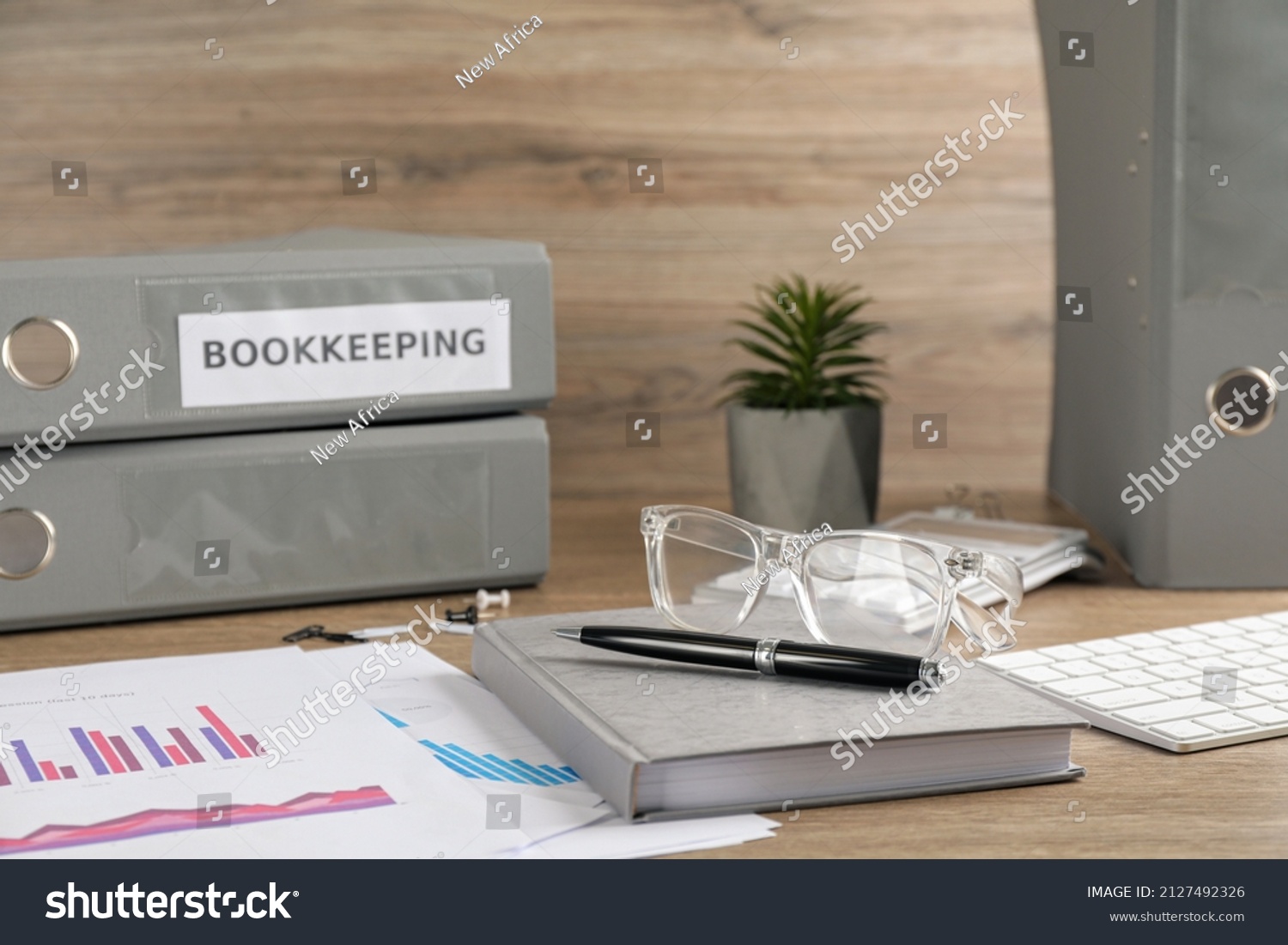 Bookkeeper's workplace with folders and documents on table #2127492326