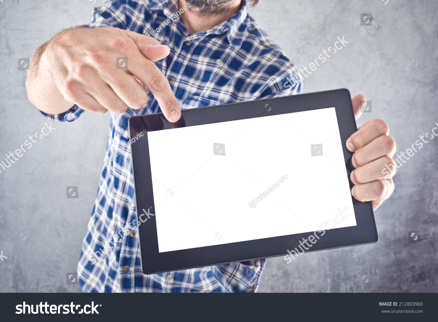 Casual man pointing to 10 inch display of digital tablet computer as copy space for your message or design. #212803960