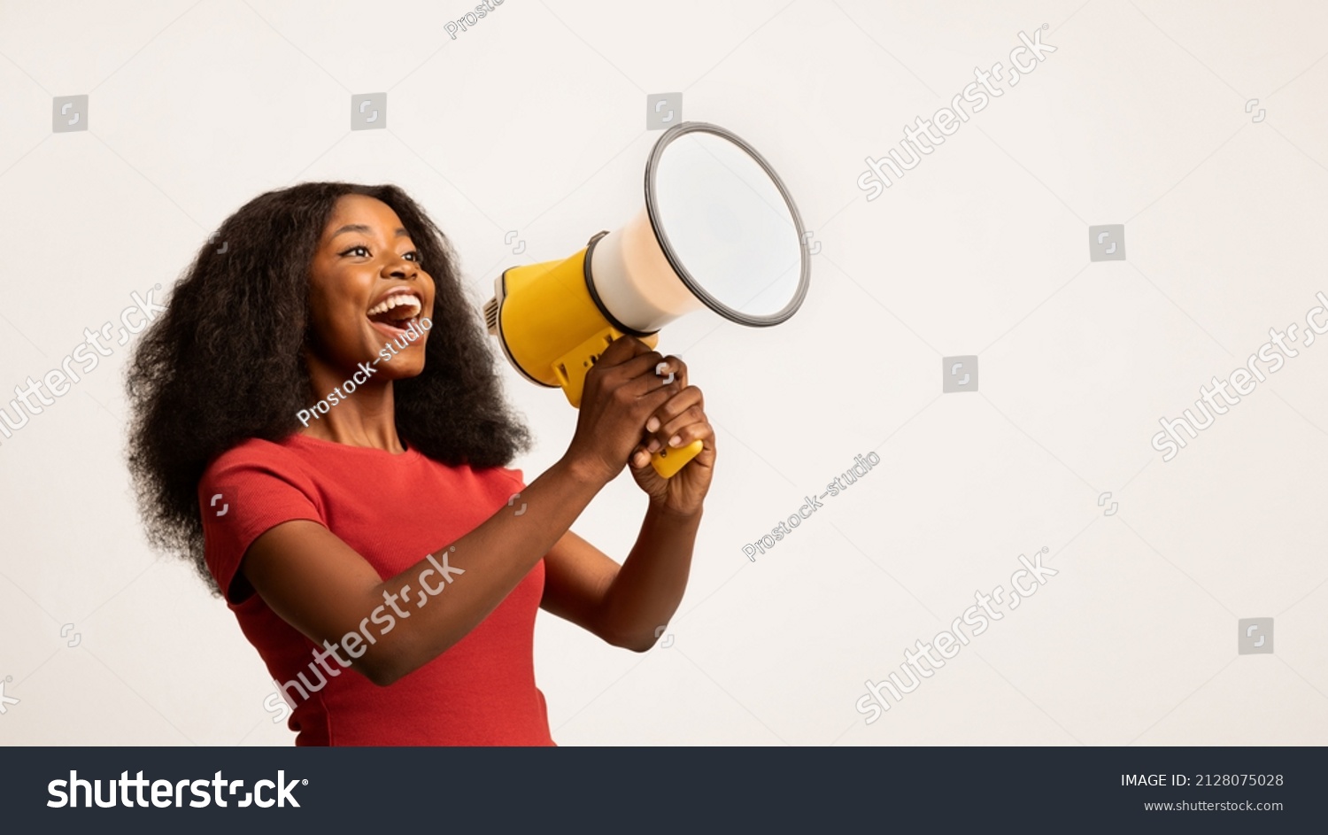 Great Promo. Excited Black Lady Using Megaphone For Making Announcement, Cheerful African American Woman Holding Loudspeaker, Sharing News While Standing On White Background, Panorama, Copy space #2128075028