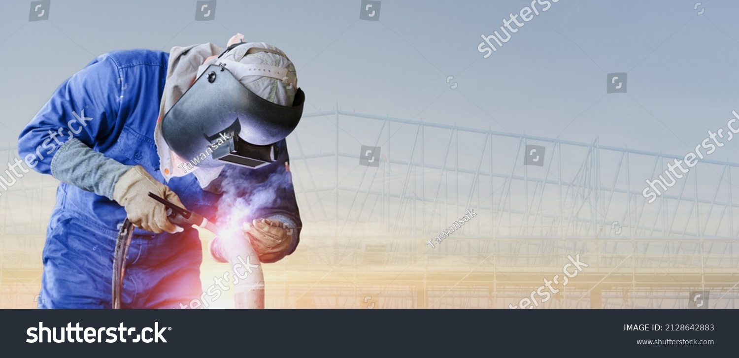 banner of worker welding metal steel pipe by TIG torch innert gas wearing safety mask and suit is welding metal panorama image construction steel with copy space
 #2128642883