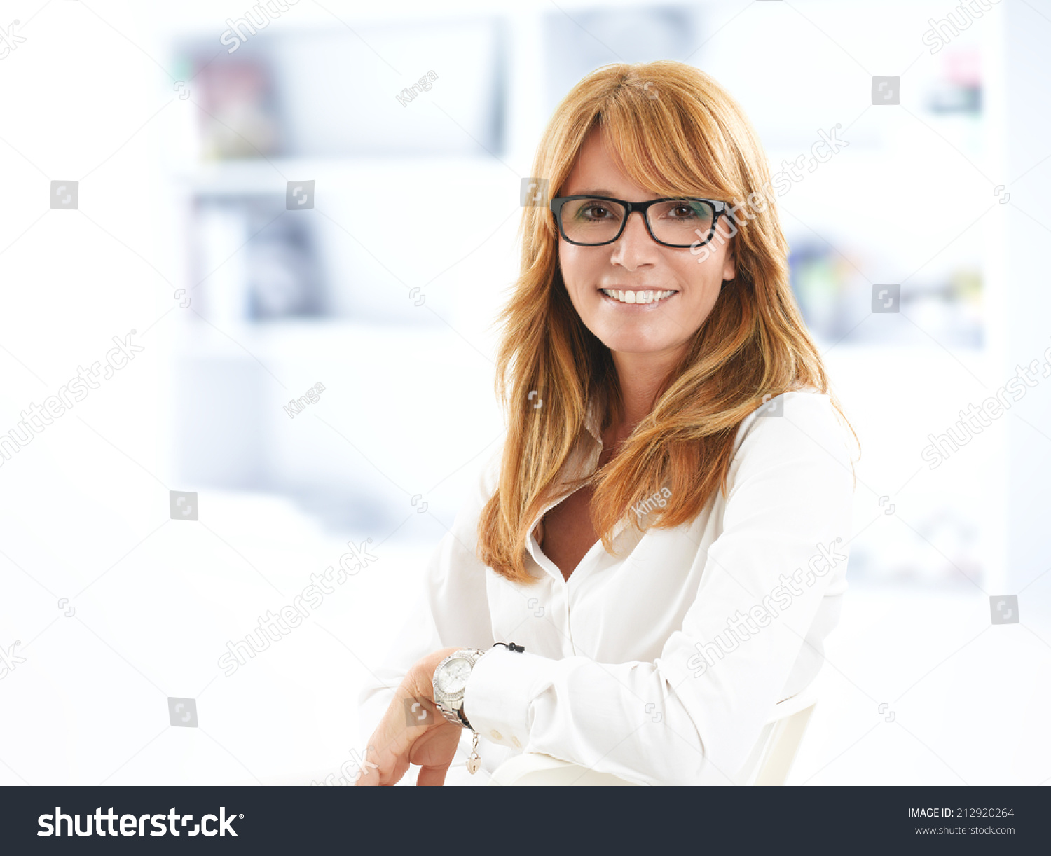 Confident businesswoman sitting at desk in office. Business people.  #212920264
