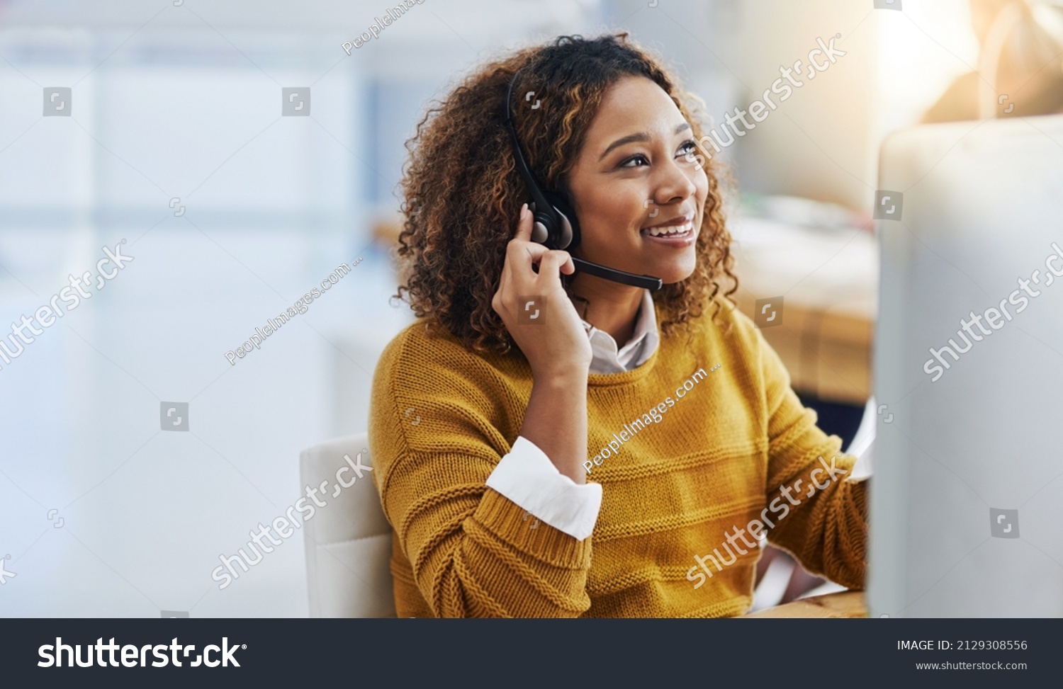 Her display of care in customers is great business. Shot of a female agent working in a call centre. #2129308556