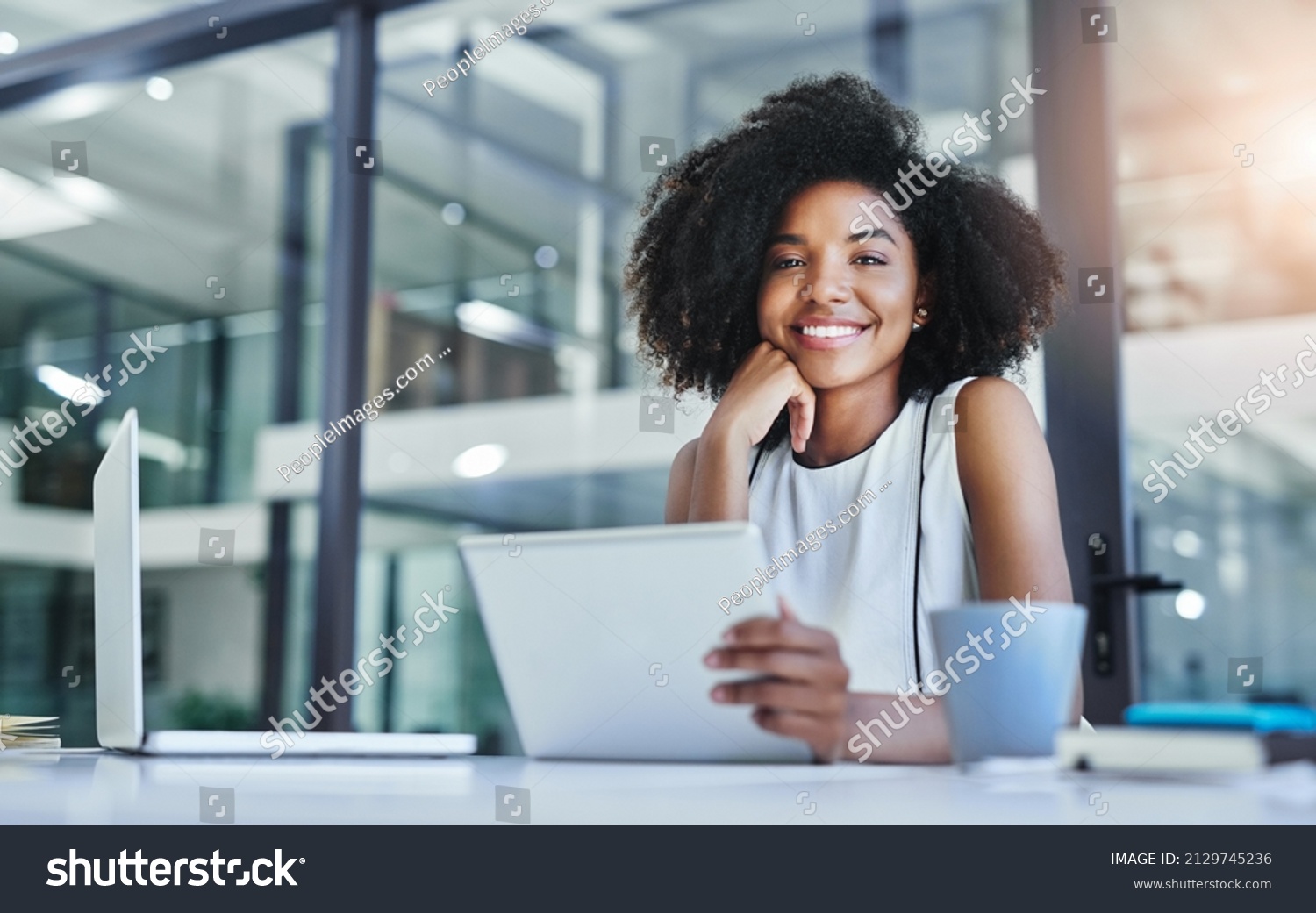 With apps like these your business will flourish. Cropped shot of an attractive young businesswoman working in her office. #2129745236