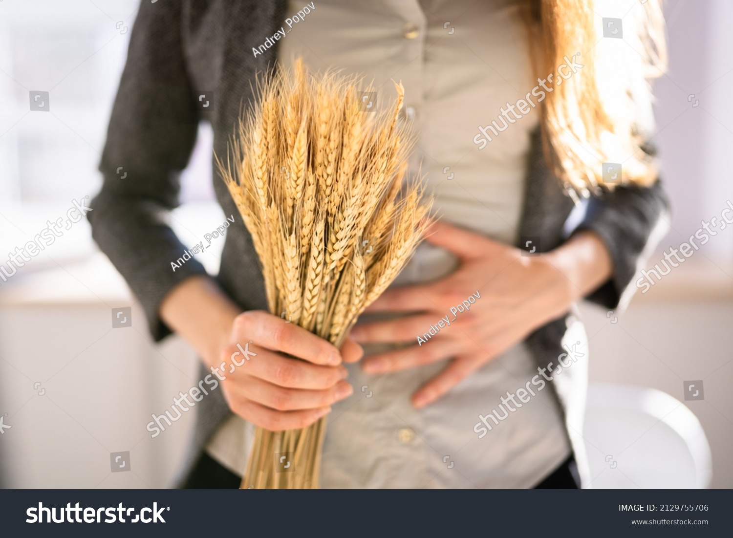 Celiac Disease And Gluten Intolerance. Women Holding Spikelet Of Wheat #2129755706