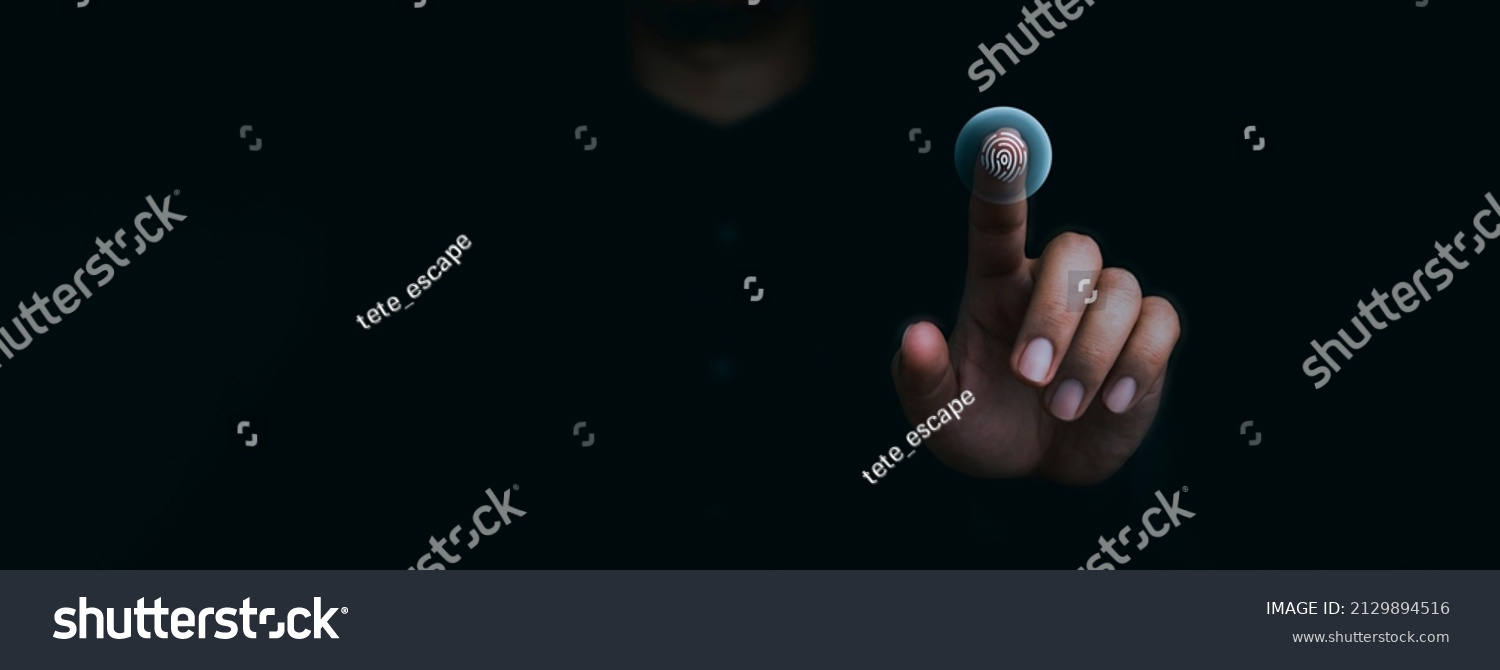 Blue fingerprint scan icon on virtual screen while finger scanning for security access with biometrics identification on dark. Cyber security, privacy data protection technology for business. #2129894516