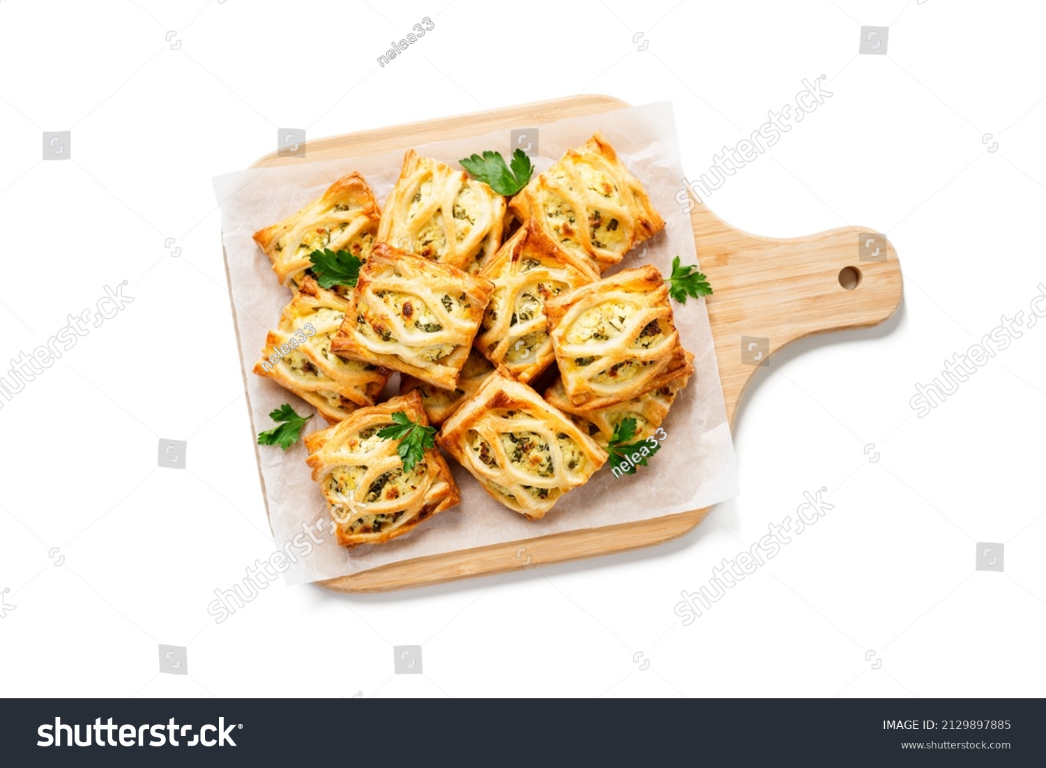 Puff pastry squares filled with feta cheese and spinach isolated on white background, top view #2129897885