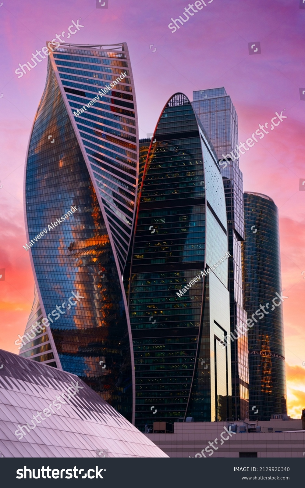 Tops of modern corporate buildings against the gloomy red sunset sky. high-rise buildings and skyscrapers Moscow International Business Center. #2129920340