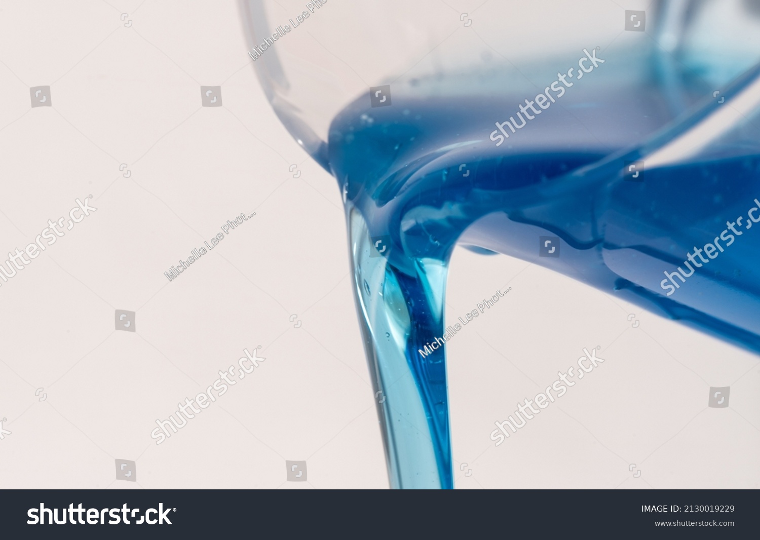 Pouring Liquid Detergent from a Cup #2130019229