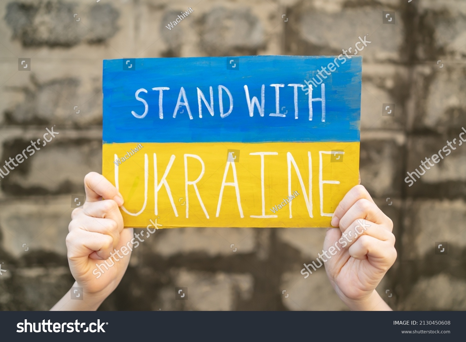 Demonstrator holding "Stand with Ukraine" placard #2130450608