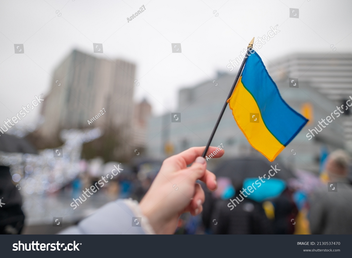 Ukrainian flag on the background of the rally. No war. Support for Ukraine #2130537470