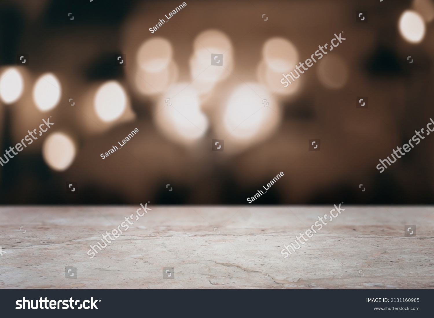 Brown marble bar counter top with empty space for text or digital product mockup. Blurred lights in the background. #2131160985