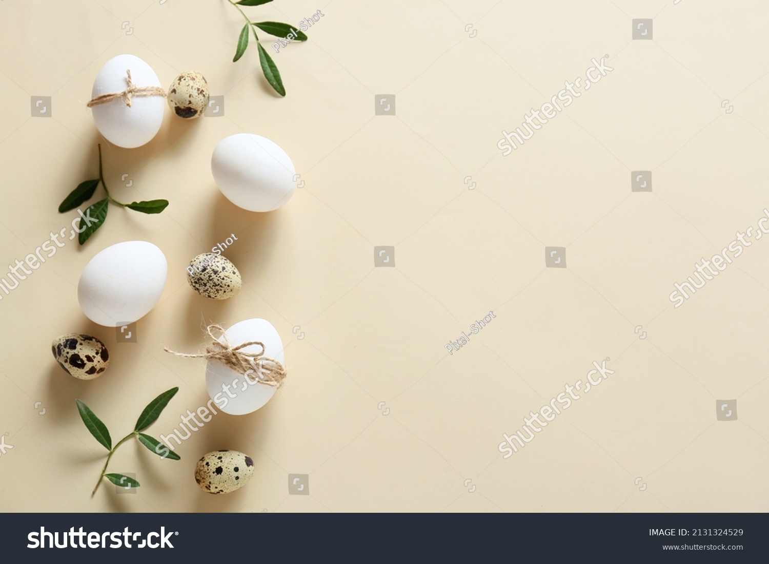 Composition with Easter eggs and green branches on beige background #2131324529