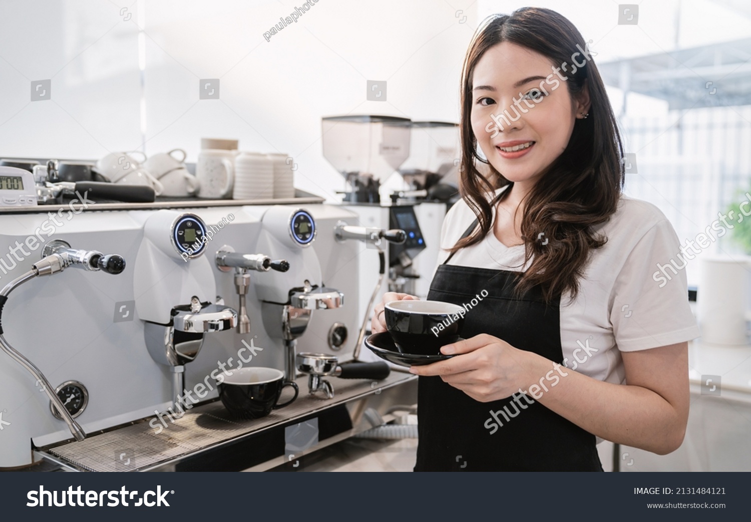 Startup successful small business owner sme woman, beauty asia girl use coffee machine in coffee shop restaurant. Portrait of asian woman barista cafe owner. SME entrepreneur business seller concept #2131484121