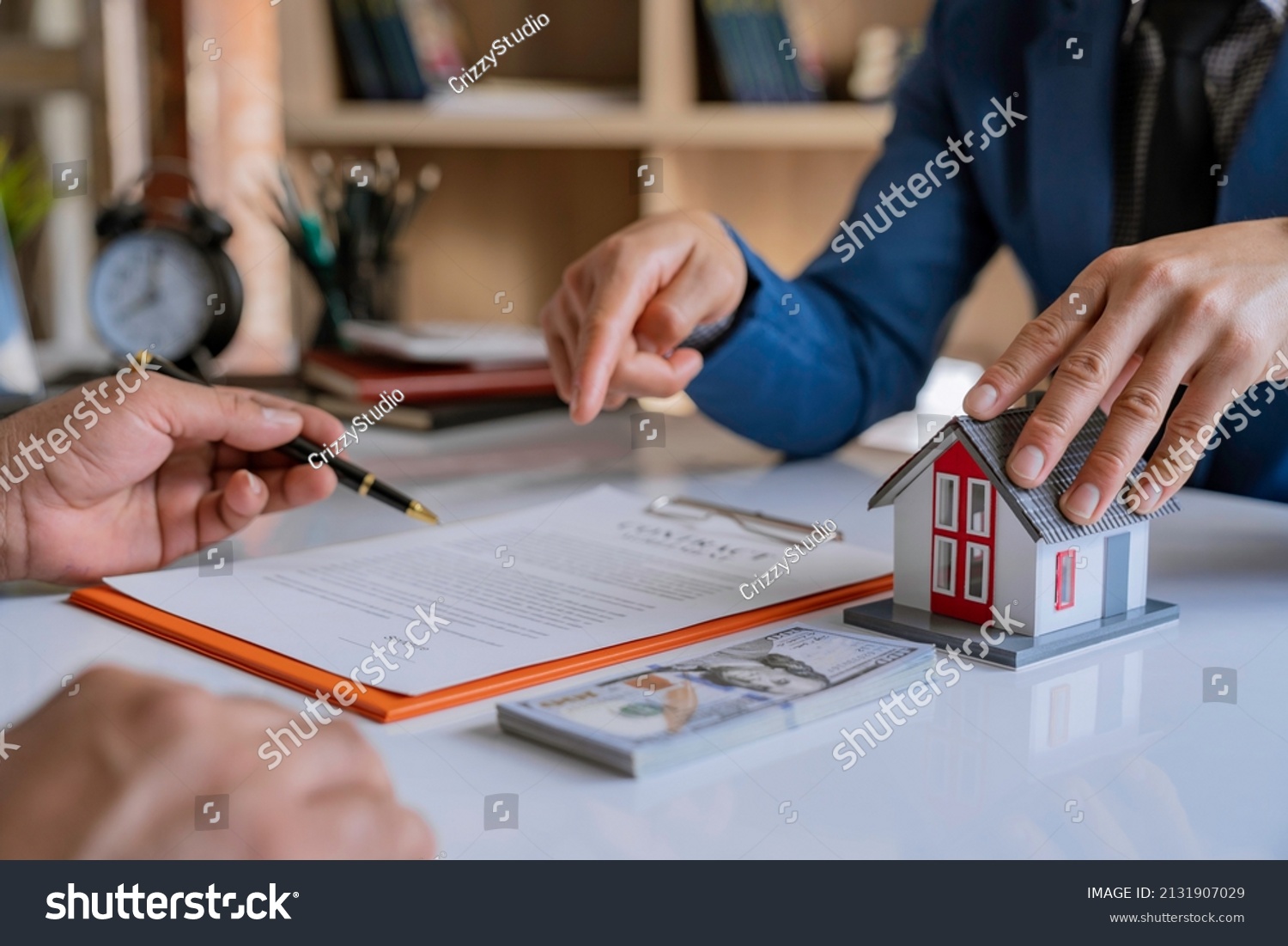Real estate broker agent presenting and consult to customer to decision making sign insurance form agreement, home model, concerning mortgage loan offer for and house insurance. #2131907029