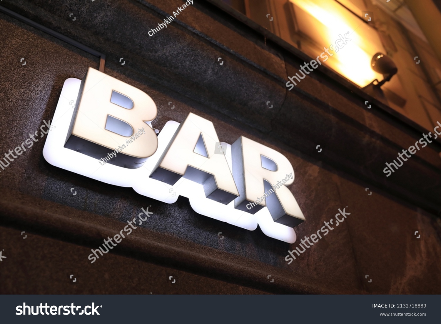 View of luminous bar signboard on wall of building at night #2132718889