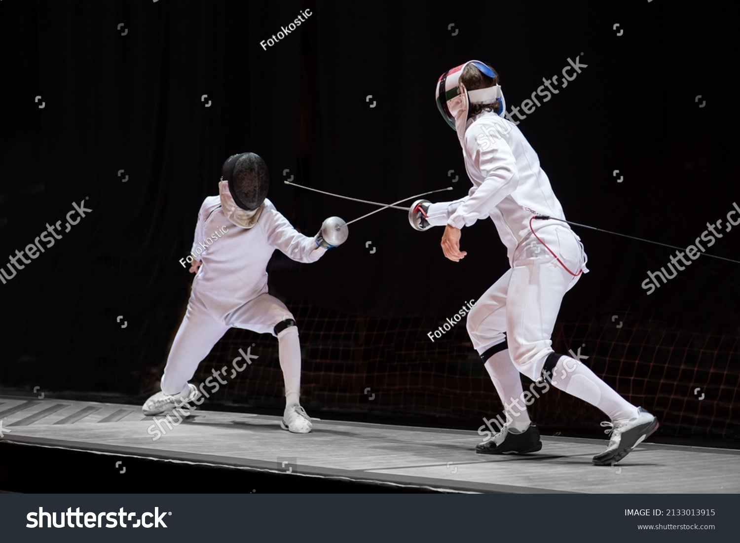 Fencer  with fencing sword. Fencers duel concept #2133013915