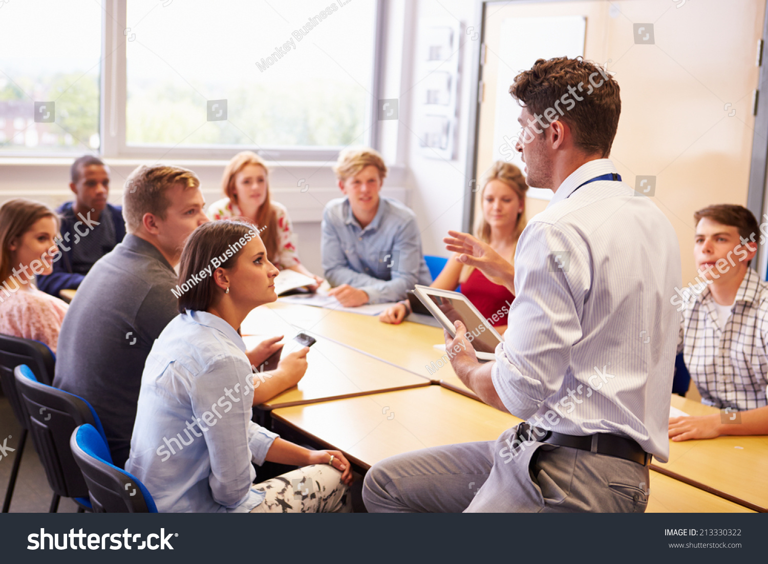 Teacher With College Students Giving Lesson In Classroom #213330322