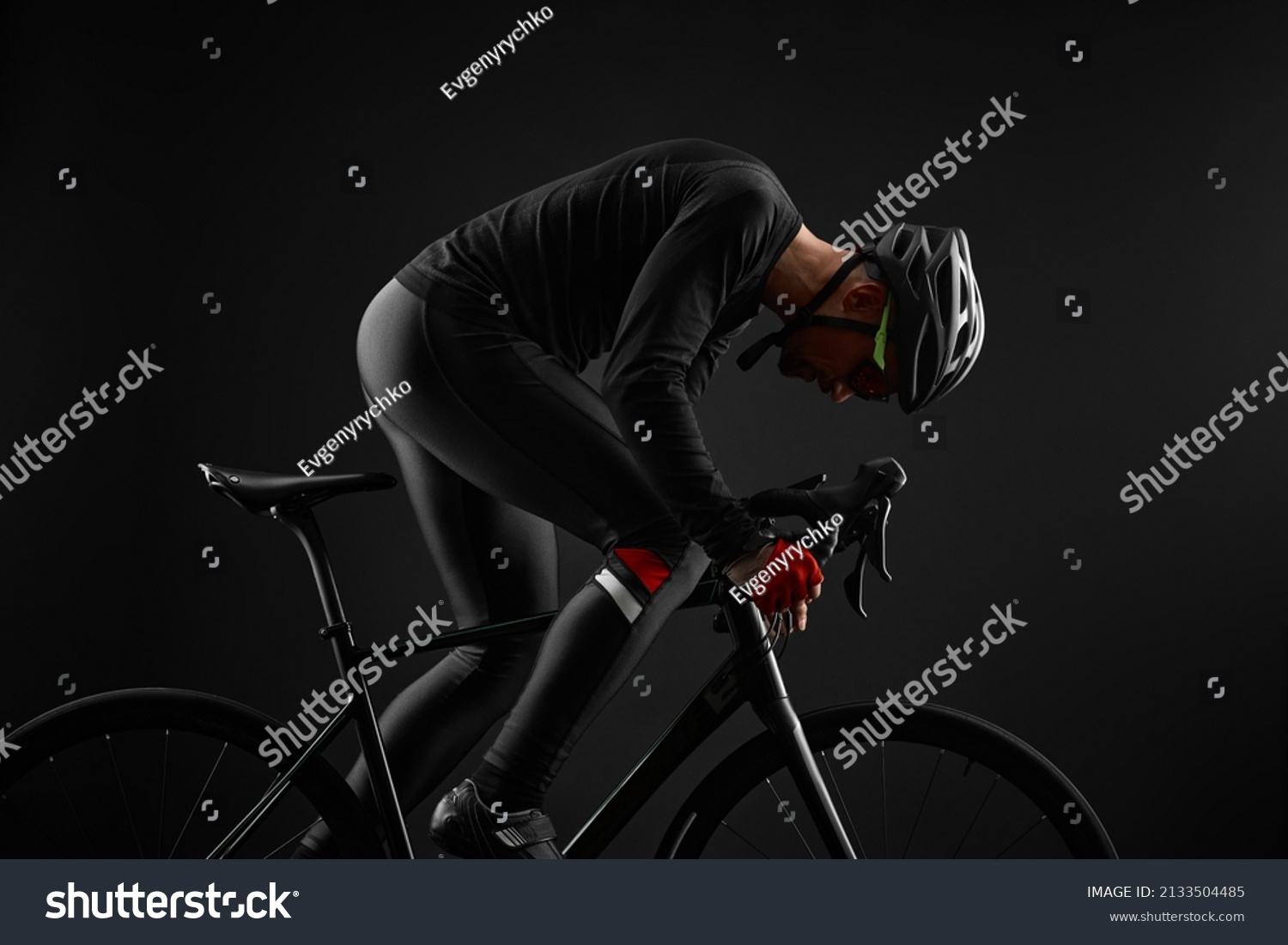 male cyclist riding road bicycle on black background #2133504485