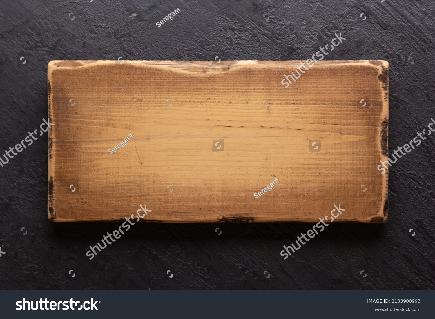 Wooden nameplate or sign board on wall background. Front view of name plate #2133900993
