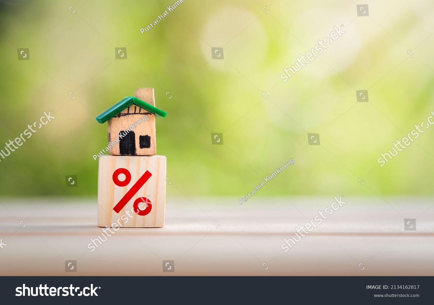 Interest rate financial and mortgage rates concept. House is placed on a wooden block with interest or tax rates,Mortgage rates business concept of investment real estate interest rates home appraisal #2134162817