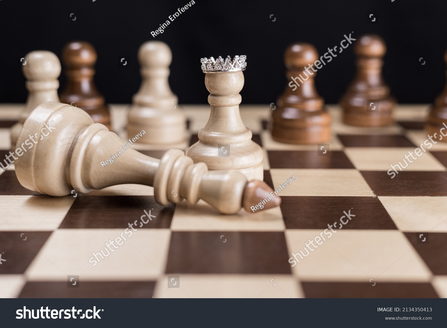 The white pawn in the crown with his team and the defeated white king.The concept of revolution, the fall of the dictatorial regime as a result of a coup, uprising, rebellion, coup d'etat #2134350413