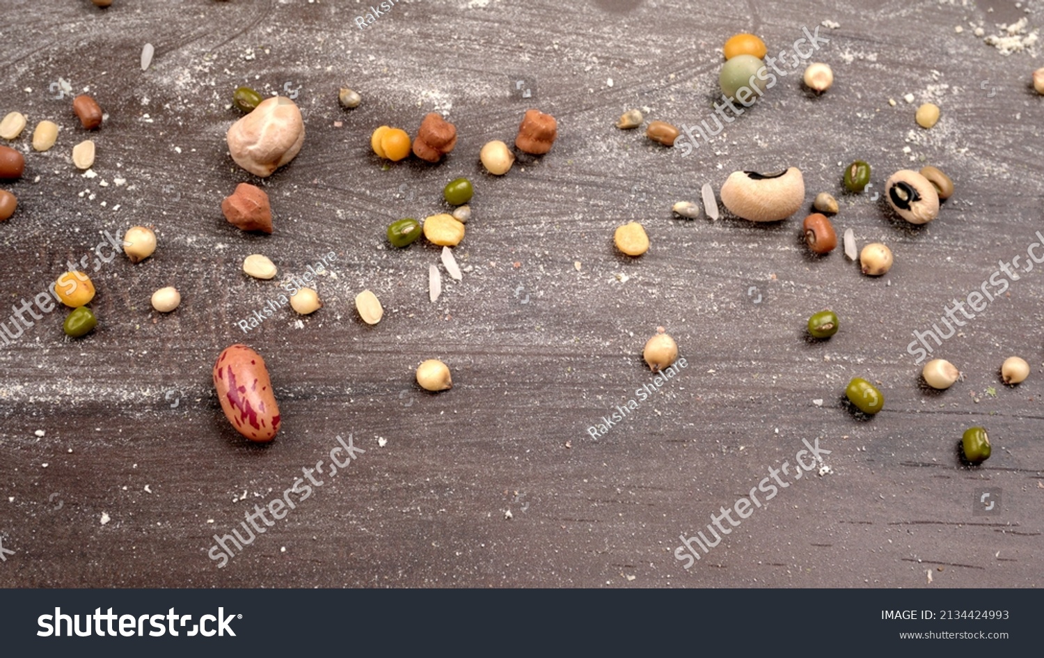 Mixed dry organic cereal and grain seed pile on wooden background. For healthy food ingredient or carbohydrate food type and agricultural product concept. #2134424993
