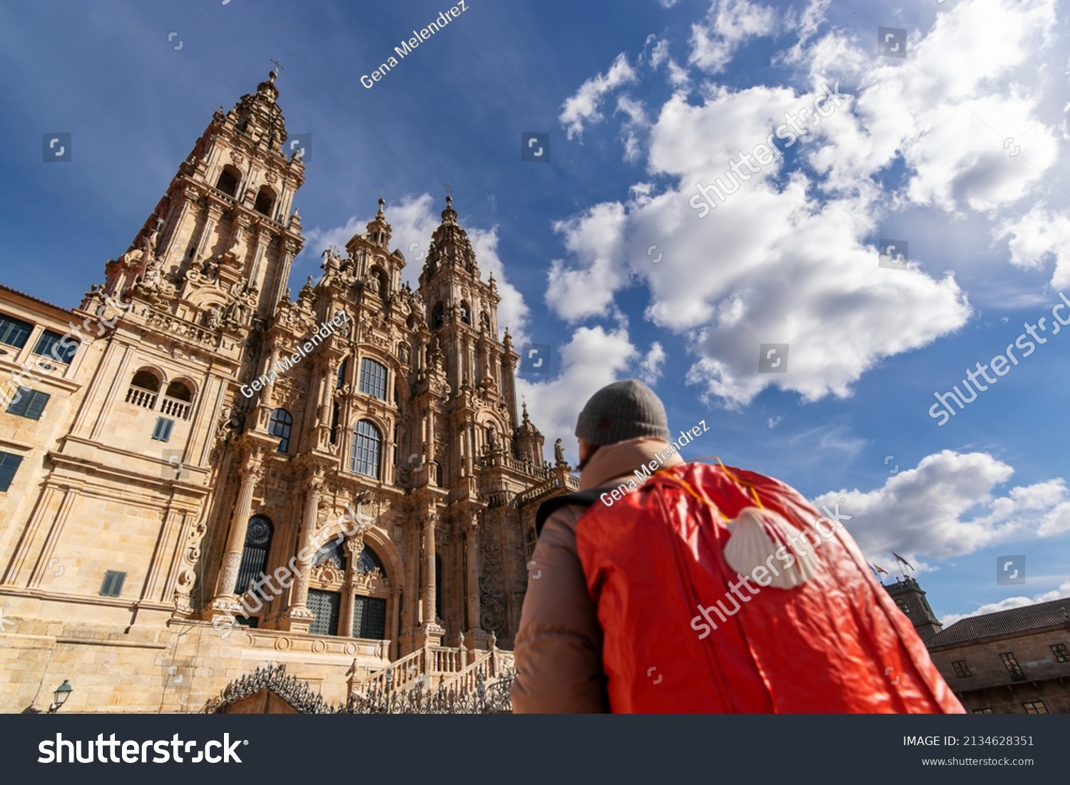 Camino de Santiago  with pilgrim woman unfocused  in Obradoiro square looking the Compostela cathedral after finishing the way of st James , Galicia, Spain #2134628351
