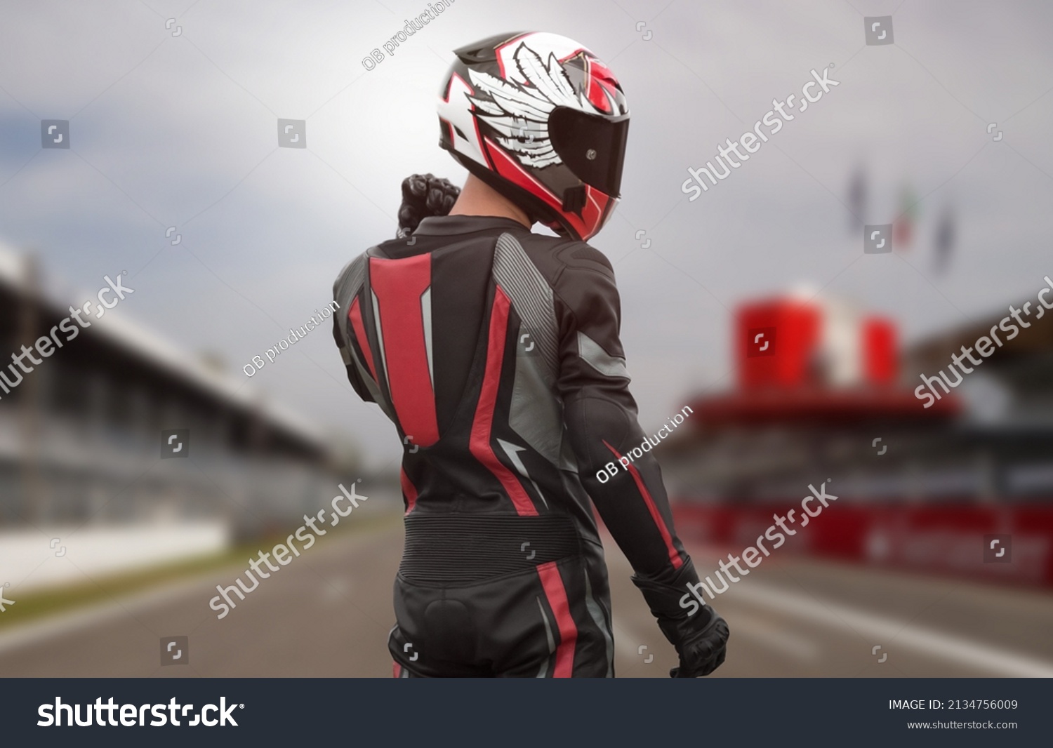 Motorcyclist in full gear and helmet on the race track. #2134756009