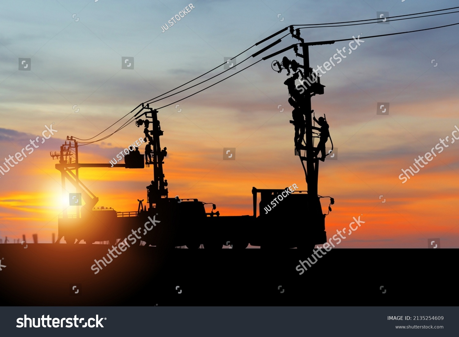 Silhouette of Electrician officer climbs a pole and uses a cable car to maintain a high voltage line system, Shadow of Electrician lineman repairman worker at climbing work on electric post power pole #2135254609