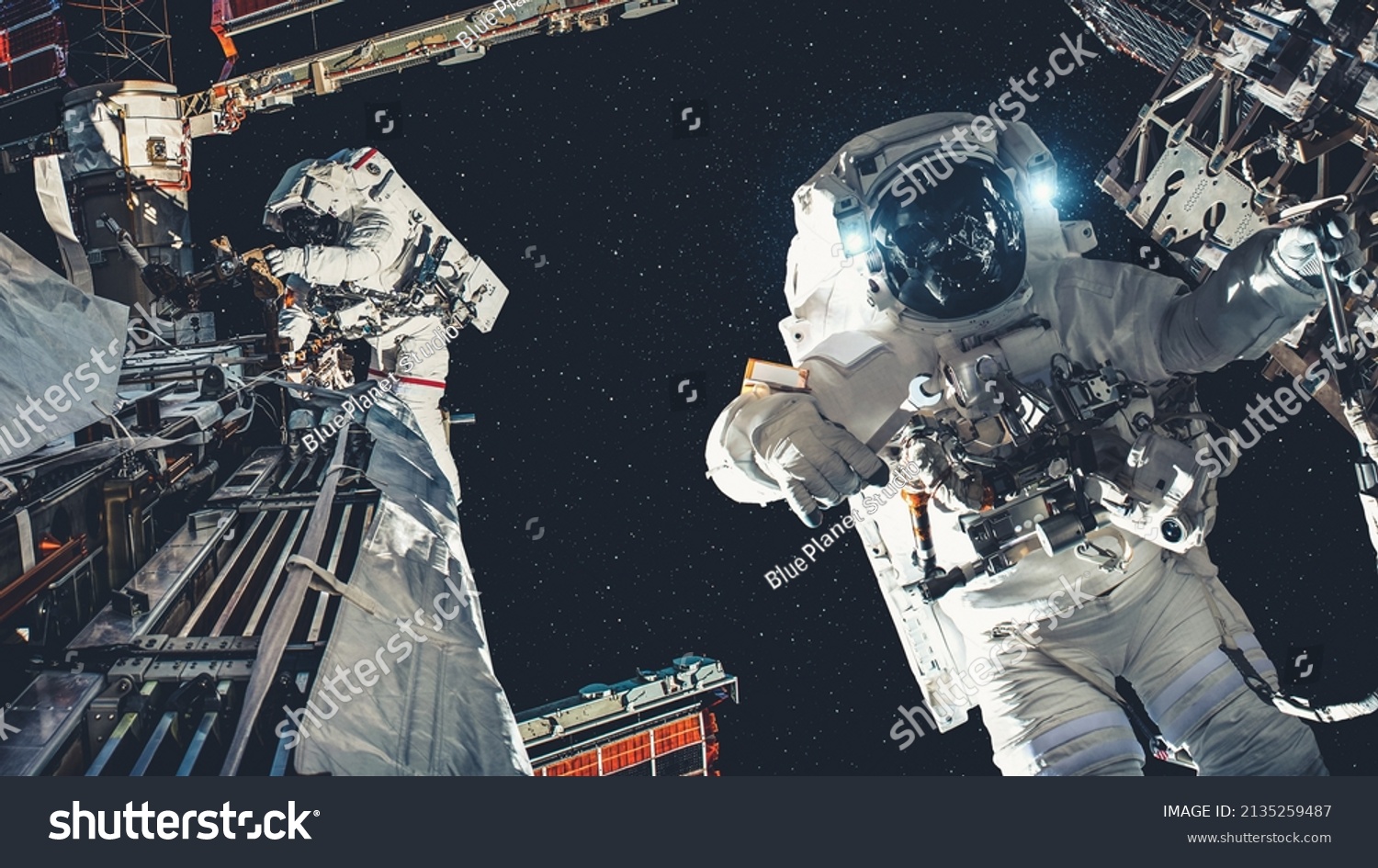 Astronaut spaceman do spacewalk while working for spaceflight mission at space station . Astronaut wear full spacesuit for operation . Elements of this image furnished by NASA space astronaut photos . #2135259487