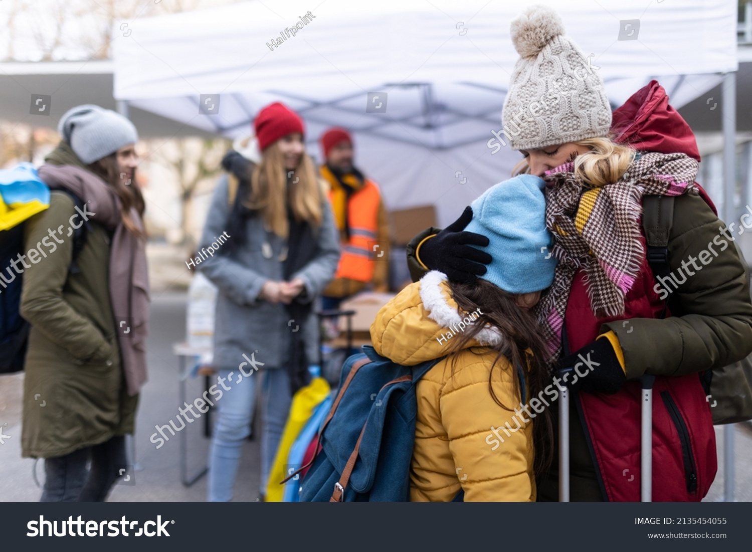 Ukrainian refugee mother with child crossing border. #2135454055