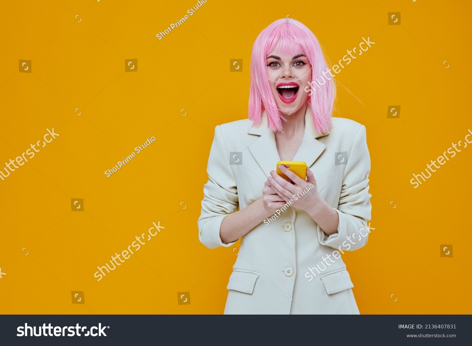 glamorous woman with pink hair cosmetics posing yellow phone in hands #2136407831