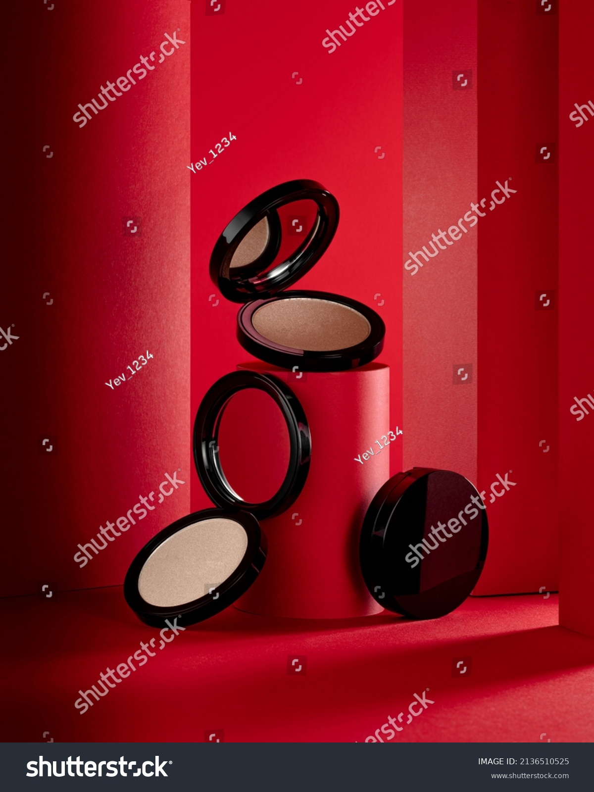 Face highlighter compact makeup powder  cases with mirror. Cosmetic products advertisement on red decorative background with decorated tubes #2136510525