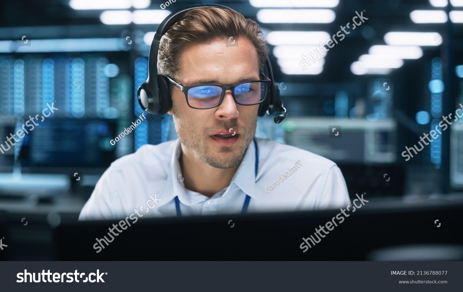 Call Center Worker Wearing Headset Working in Office to Support Remote Customer. Call Center, Telemarketing, Customer Support Agent Provide Service on Video Conference Call. #2136788077
