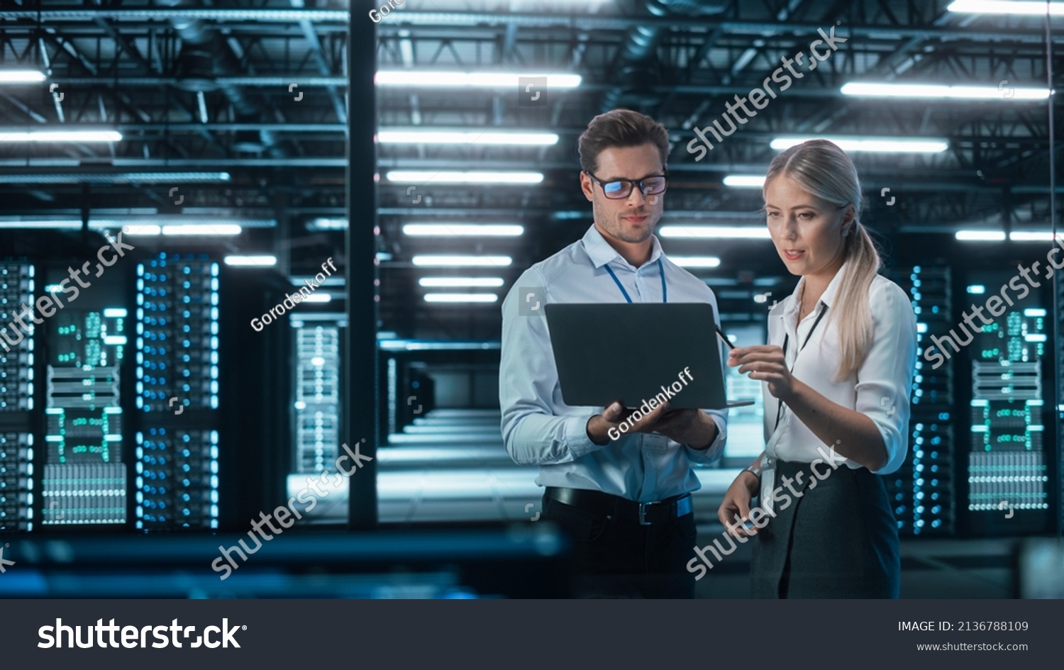 Male and Female Programmers Talking about Work, Solving Problems Together, Using Laptop Computer. Software Development  Code Writing  Website Design  Database Architecture Concept #2136788109