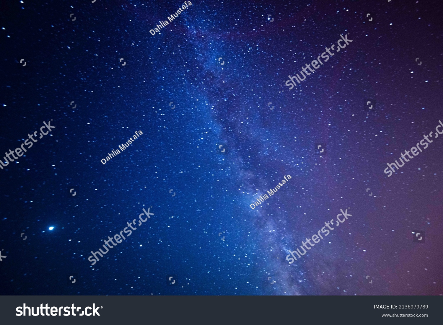 Astro photography in a desert nightscape with milky way galaxy. The background is stary celestial bodies in astronomy.
 #2136979789