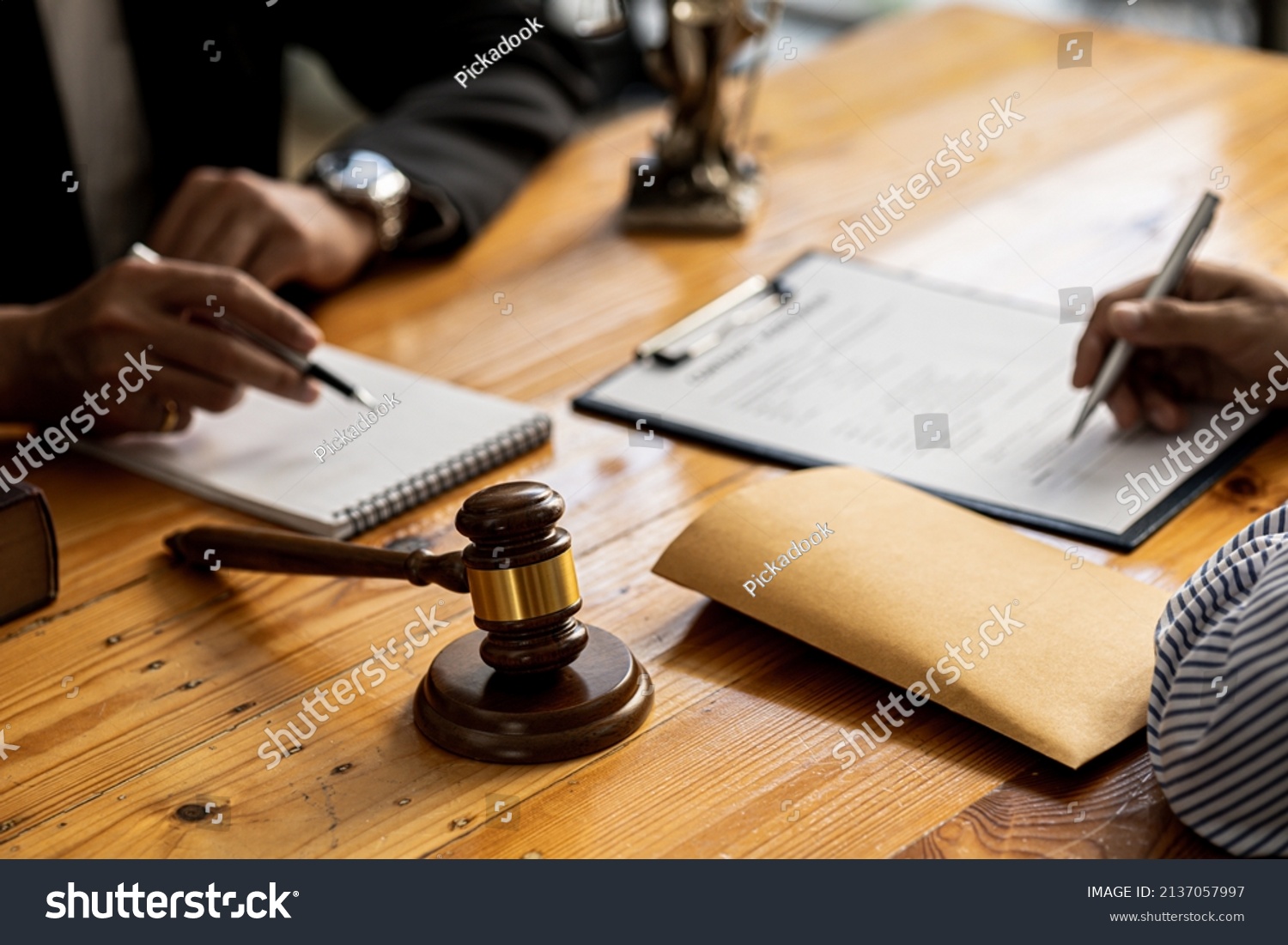 Client was listening to a lawyer advising on an embezzlement case, explaining the details of the proceeding and gathering evidence to file a lawsuit against the defendant. The concept of litigation. #2137057997