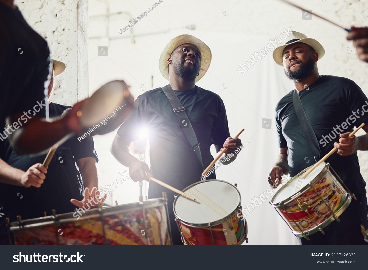 Their beats are on a whole new level. Shot of a group of musical performers playing drums together. #2137126339