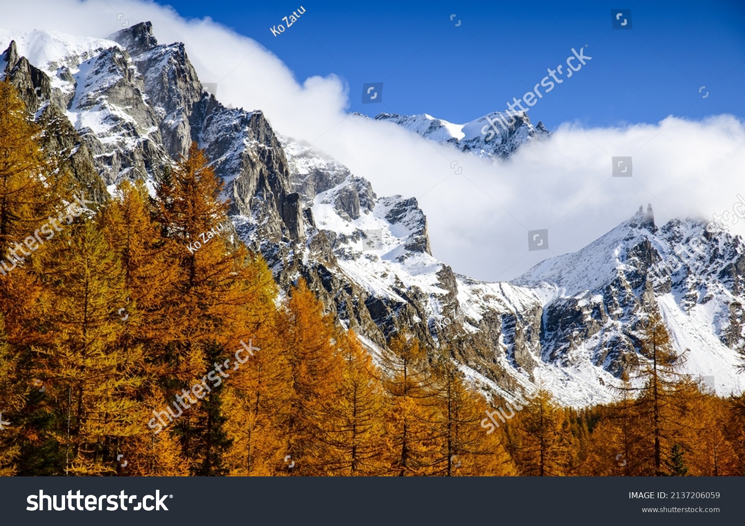 Mountain peaks snow in autumn. Autumn snow on mountain peaks #2137206059