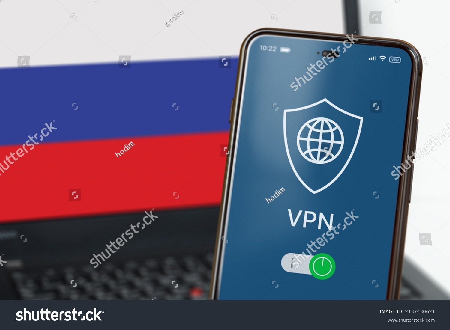 VPN in Russia. A smartphone with VPN turned on in the foreground and a laptop screen with the flag of Russia in the background. Using VPN on cell phone and computer. Selected focus #2137430621