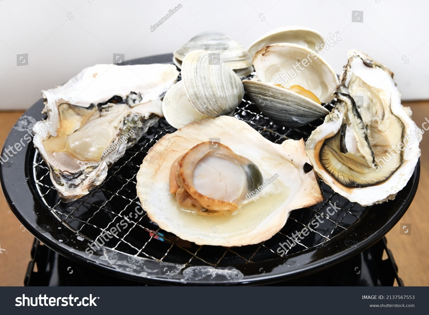 Seafood barbecue grilling shellfish on the net #2137567553