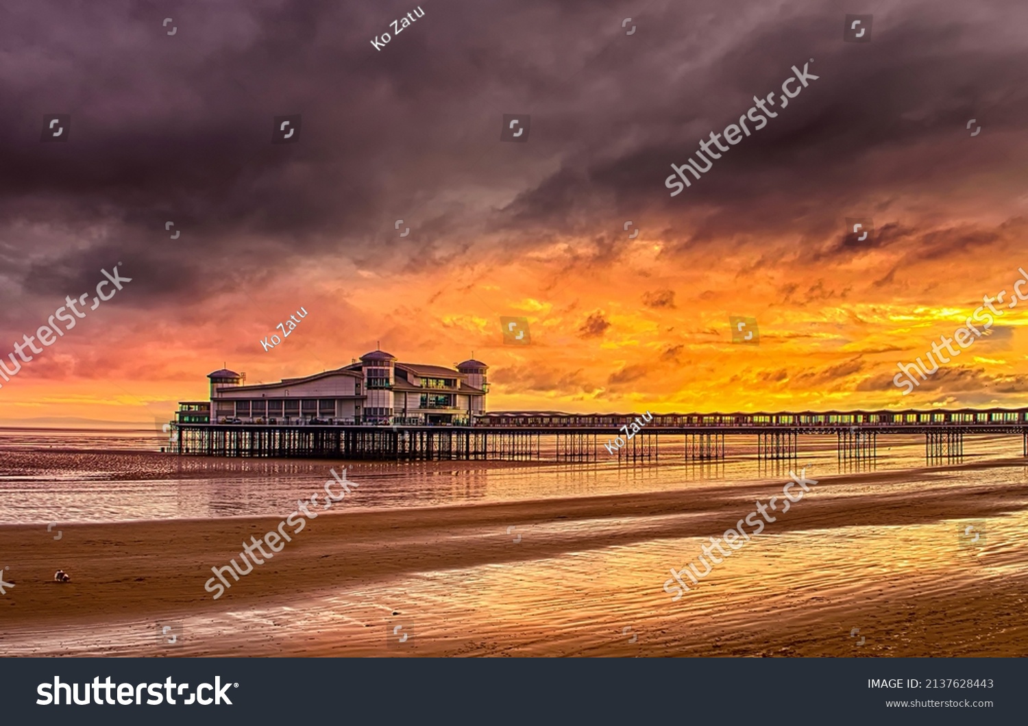 View from the beach to the pier at sunset landscape #2137628443