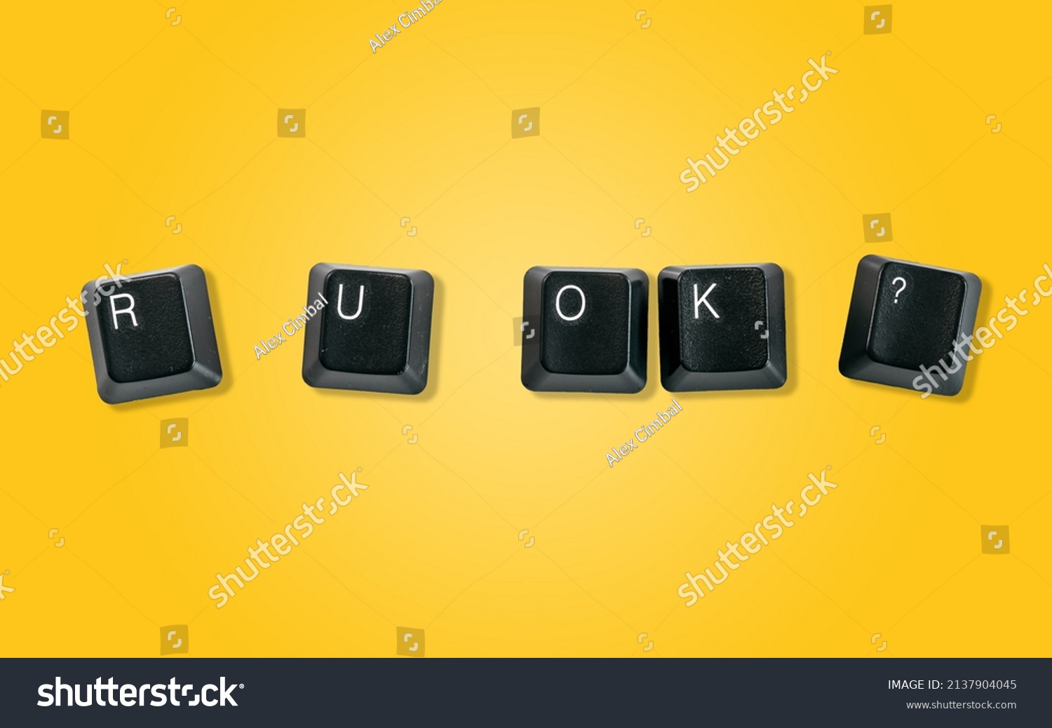 Computer keyboard keys spelling R U OK?, isolated on a yellow background #2137904045